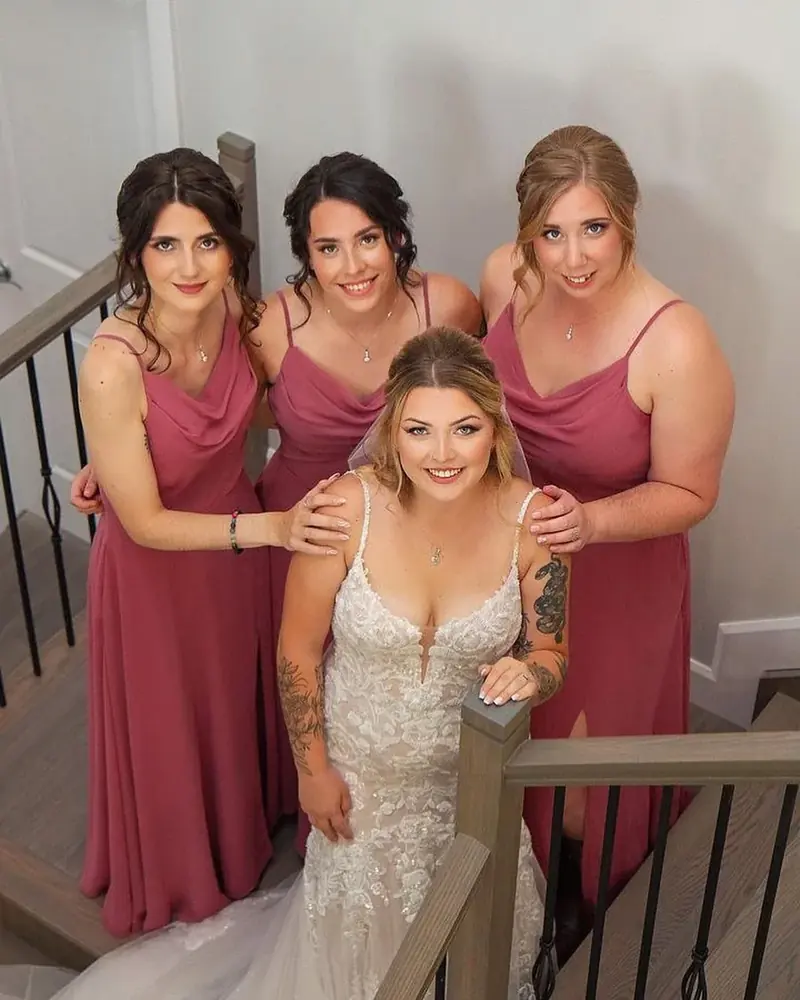 Bride and her three bridesmaids in rose dresses